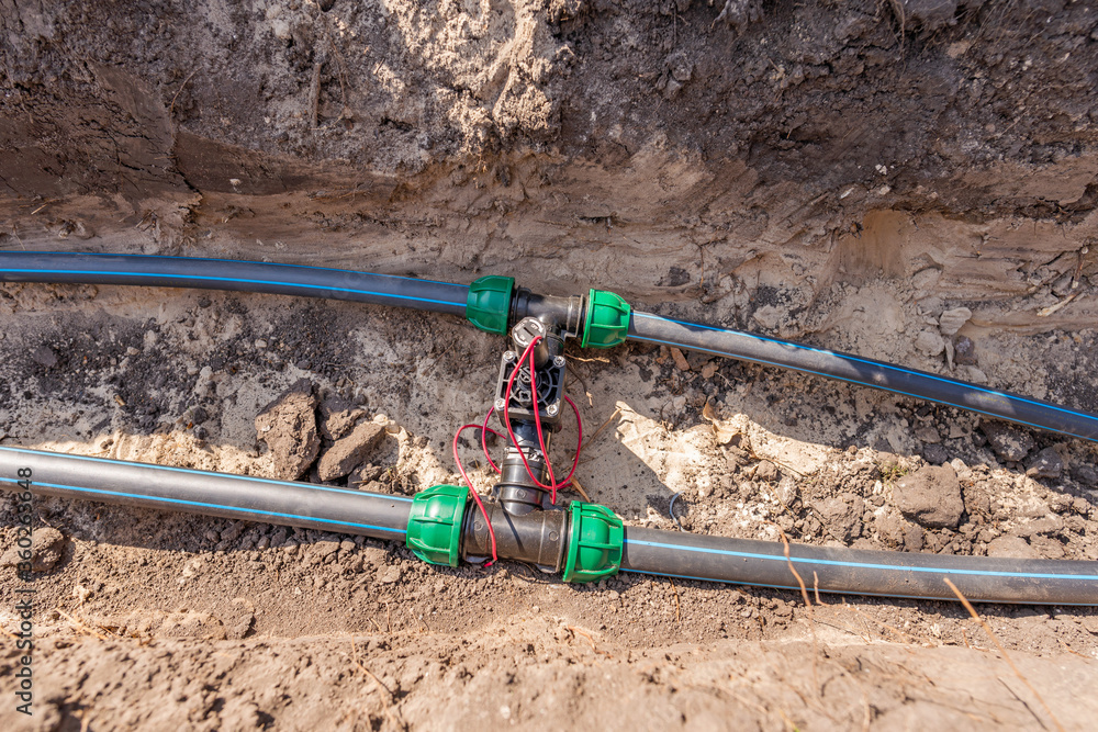 Water pipes (tubes) and control valves for irrigation system placed in