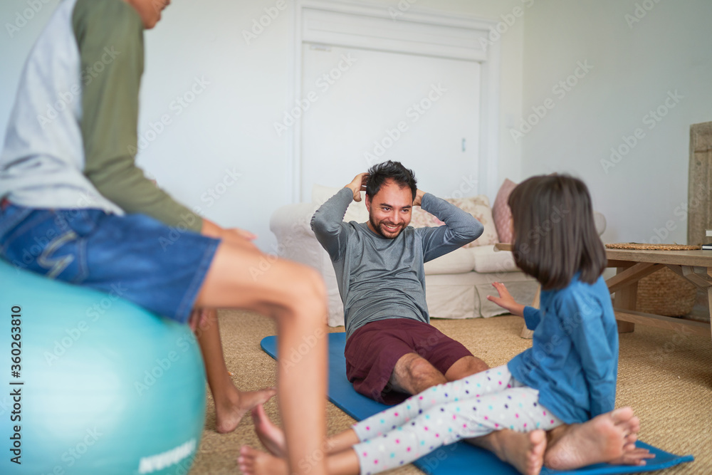 Father and kids exercising in living room Father and kids exercising in living room