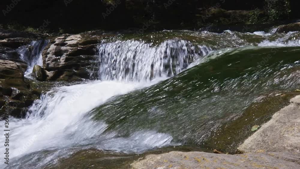 Small mountain creek flows among stones and autumn trees in the forest. Small mountain creek flows among stones and autumn trees in the forest.