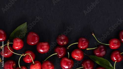 cherry on dark background with copy space. Top view. Flat lay