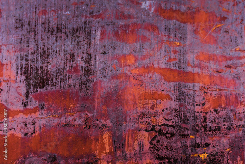 The old iron background is painted in red, pink, purple with rust and chips.