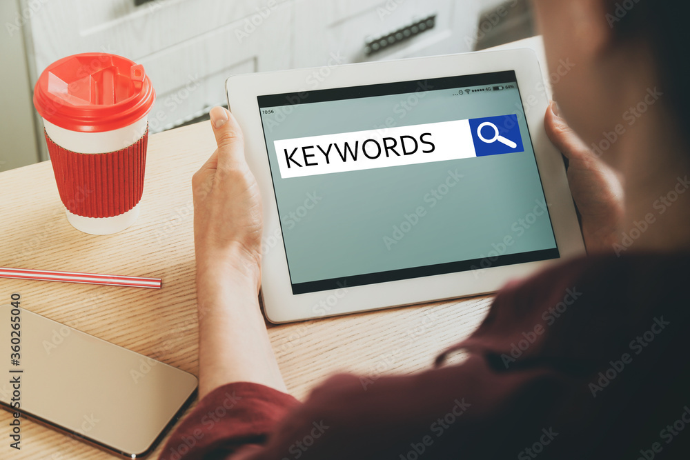 Woman with tablet searching for keywords at table, closeup Woman with tablet searching for keywords at table, closeup