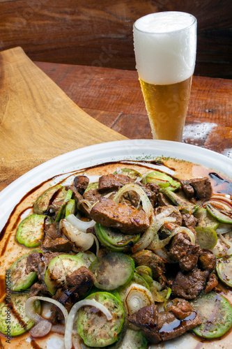 Scarlet eggplant, jiló with onion liver passed in the frying pan photo