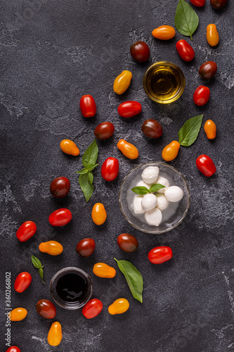 Ingredients for caprese salad: tomatoes, mozzarella and basil.