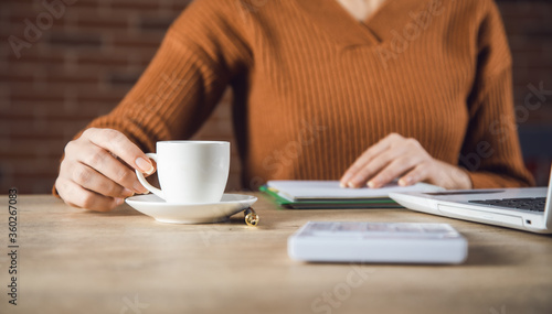 woman hand coffee and notepad in office