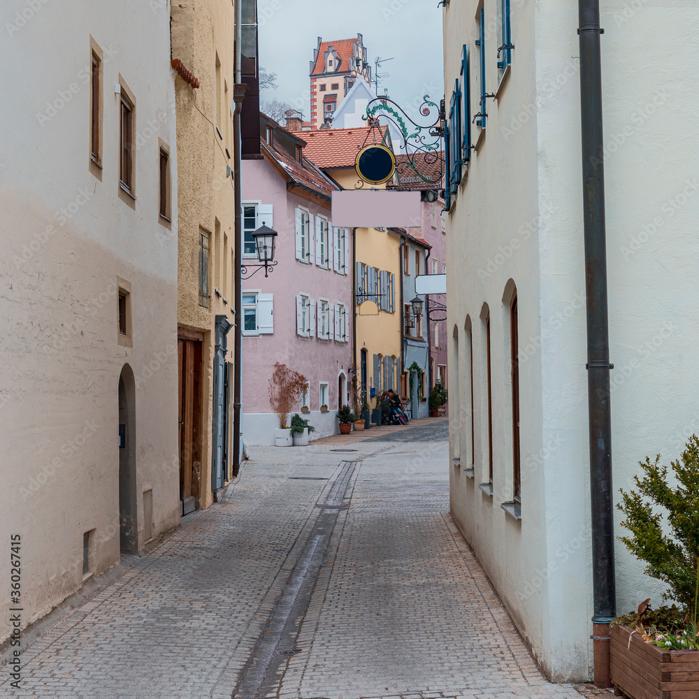 Fototapeta premium narrow cobbled street with old houses in the old German city of Fissen