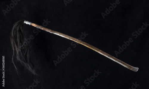 ancient wooden staff for magic isolated on black background