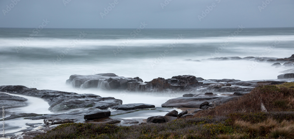 a soft focus and long exposure creates a tranquil mood of this rocky, coastal scene at Yachats, Oregon.