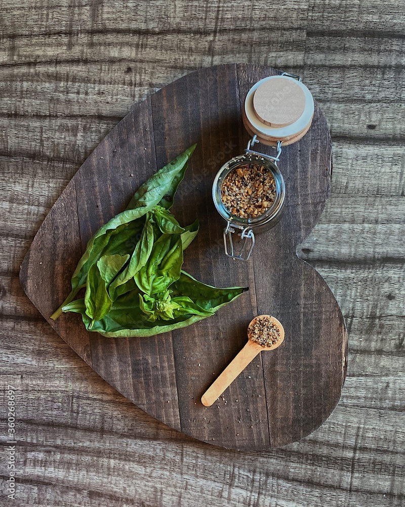 basil with spices on a dark wooden board basil with spices on a dark wooden board