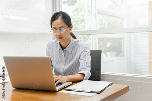 Attractive asian women working with laptop, Work from home. © mojo_cp