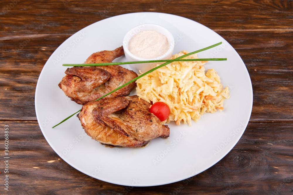 Fried chicken with seasoning, served with cabbage
