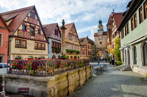 ROTHENBURG OB DER TAUBER  GERMANY - OCTOBER 18  2016  The Markus Tower  Markusturm  and old buildings on the Rodergasse street.