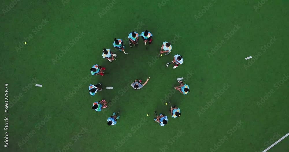 Field Hockey Team Players Standing In Circular Formation While The Coach Giving Them