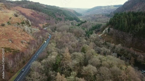 Aerial view of Welsh valley and cars on a470, dense forest day time Wide shot Wales photo