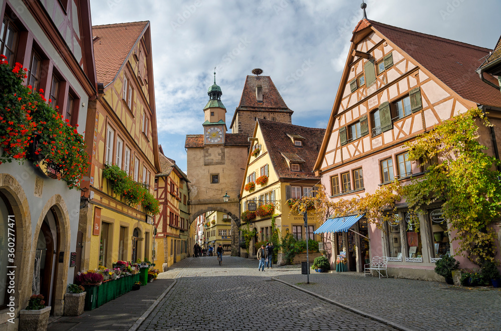ROTHENBURG OB DER TAUBER, GERMANY - OCTOBER 18, 2016: The Markus Tower (Markusturm) and old buildings on the Rodergasse street.