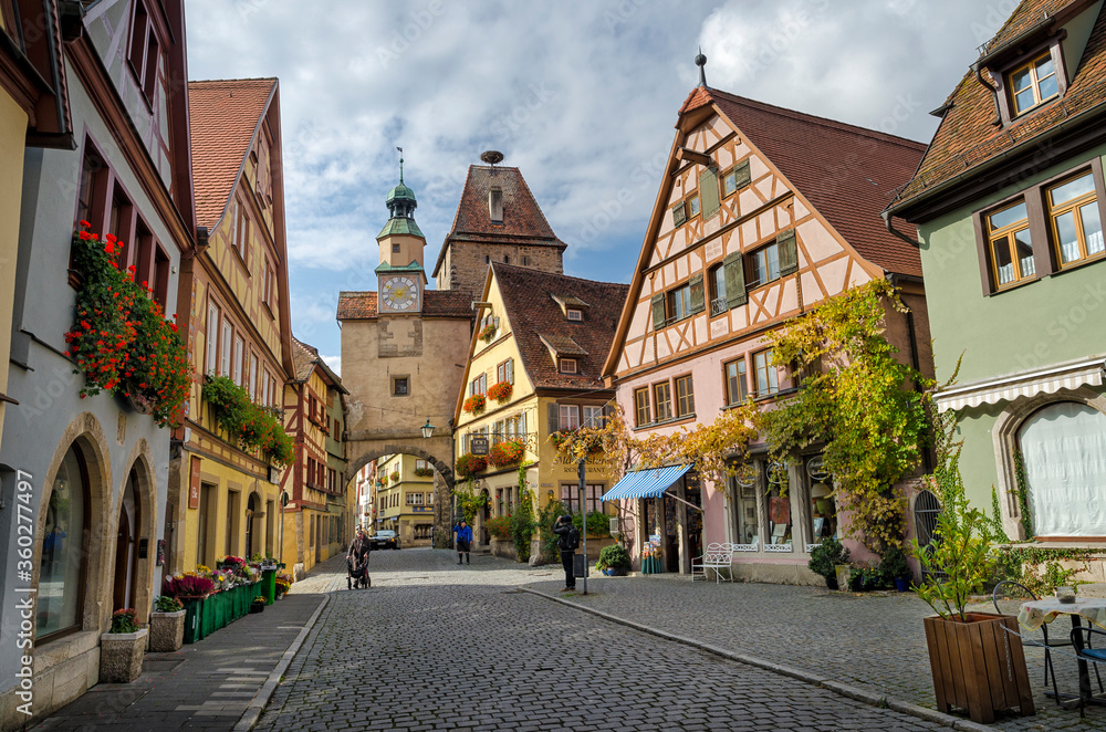 ROTHENBURG OB DER TAUBER, GERMANY - OCTOBER 18, 2016: The Markus Tower (Markusturm) and old buildings on the Rodergasse street.