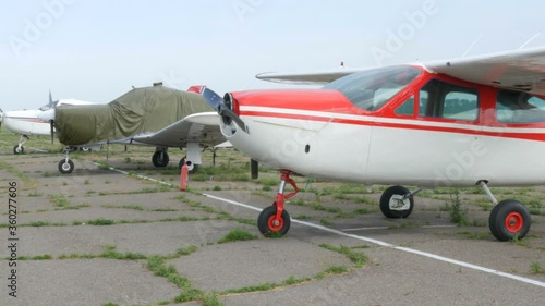 A number of small passenger aircraft stand at the airport. photo