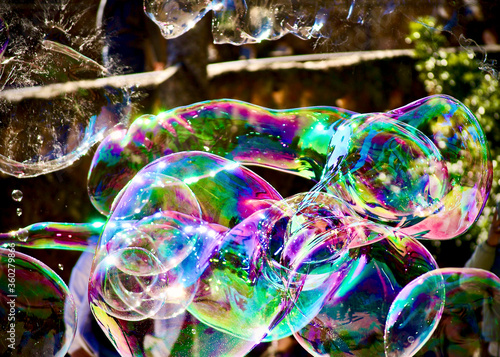 multicoloured big soap bubbles street artist in park Guell Barcellona