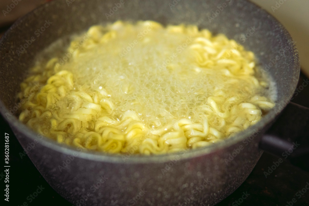 Instant noodle in a boiling pot of water. Boil the noodles in a pot with water. Selective Focus. Instant noodle in a boiling pot of water. Boil the noodles in a pot with water. Selective Focus.