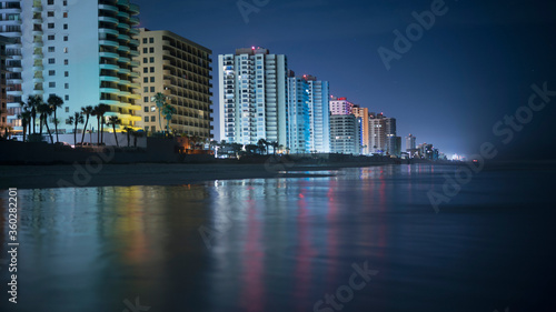 Illuminated buildings by beach in city at night, Daytona, Florida, USA photo
