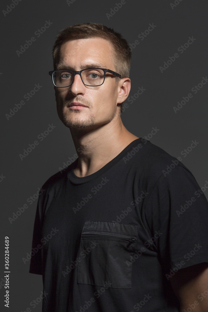 Portrait of mid adult man wearing eyeglasses standing against gray background Portrait of mid adult man wearing eyeglasses standing against gray background