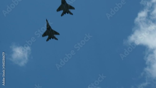 Column military warplanes flies over the ground in honor of the victory parade . Military planes in a beautiful blue sky. Air force parade.