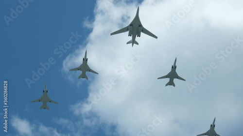 Column military warplanes flies over the ground in honor of the victory parade . Military planes in a beautiful blue sky. Air force parade.