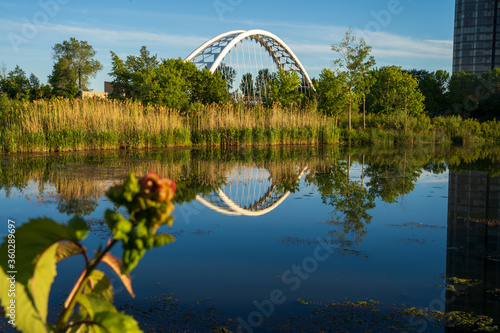 Water reflection of modern bridge in Canada