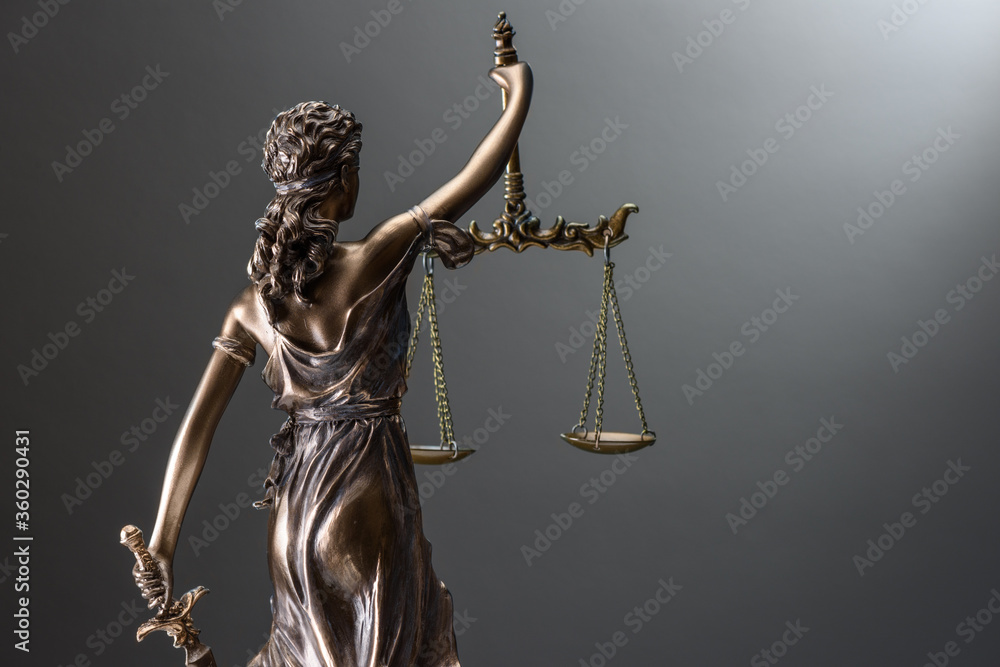 Statue of justice on gray Statue of justice on gray