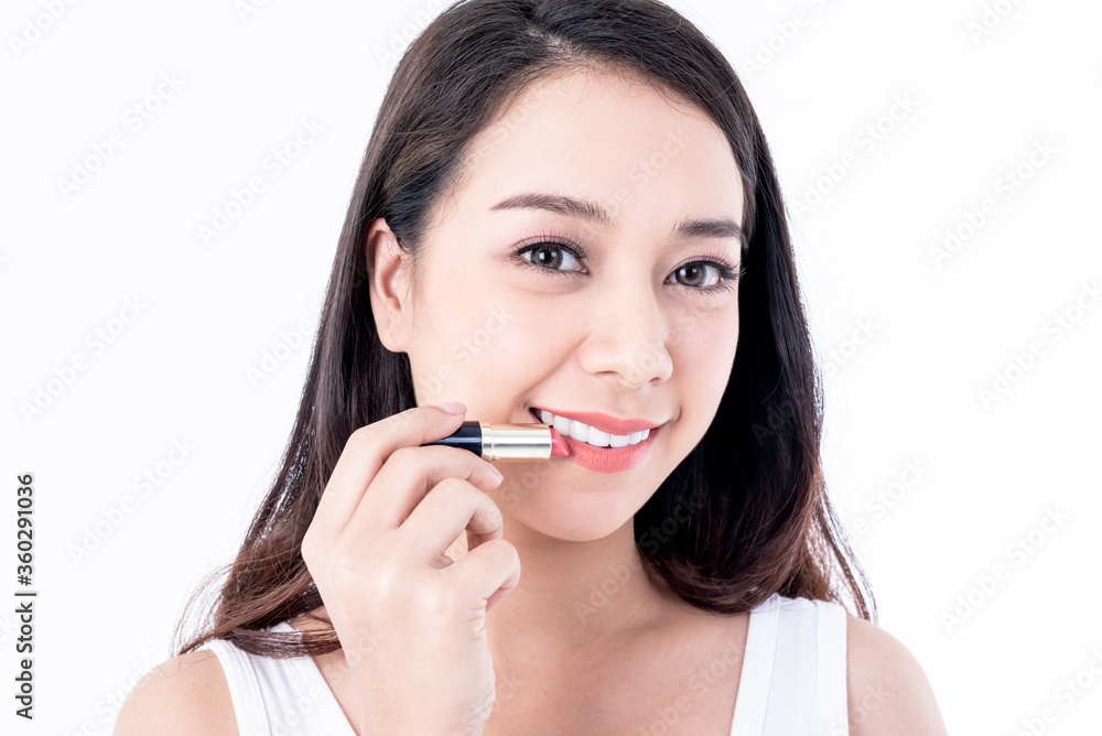 Portrait images of Asian young, pretty woman is 25 years old are holding lipstick On white background, to people and beauty concept. Portrait images of Asian young, pretty woman is 25 years old are holding lipstick On white background, to people and beauty concept.