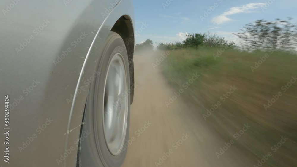 car back wheel on a countryside road car back wheel on a countryside road
