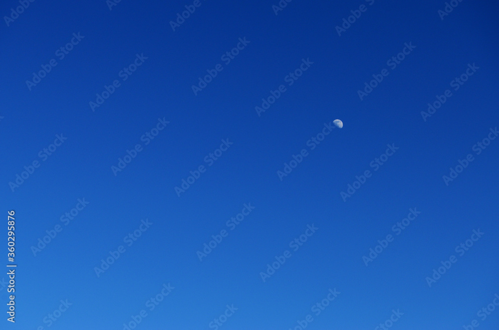 young moon in the blue sky without clouds in the style of minimalism young moon in the blue sky without clouds in the style of minimalism