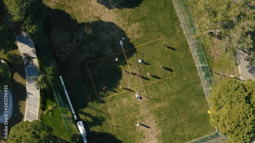 Aerial View of Soccer Field with football players. Drone footage 4K.