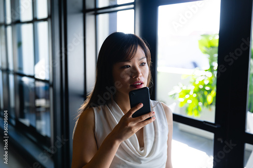 Asian woman talking to her phone Free Download Asian woman talking to her phone - GFXLoad