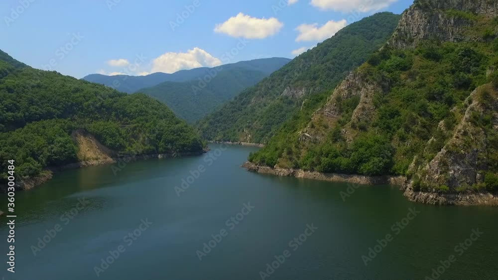 Mountain lake with turquoise water and green trees. Reflection in the water. Beautiful spring landscape with mountains, forest and lake. Aerial View. Drone shot over a beautiful mountain forest lake. Mountain lake with turquoise water and green trees. Reflection in the water. Beautiful spring landscape with mountains, forest and lake. Aerial View. Drone shot over a beautiful mountain forest lake.