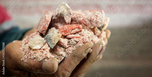 A worker holds a piece of sylvinite mineral ore