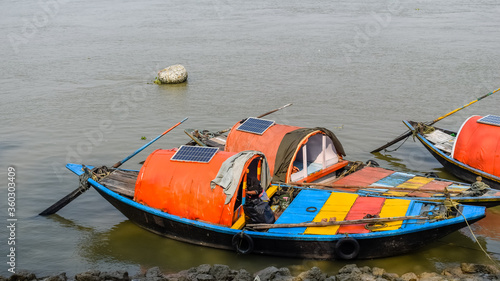 Solar panel fitted at the roof top for green energy on boats anchored at the bank of river Ganga.