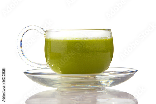 Green drink in a beautiful glass on White background