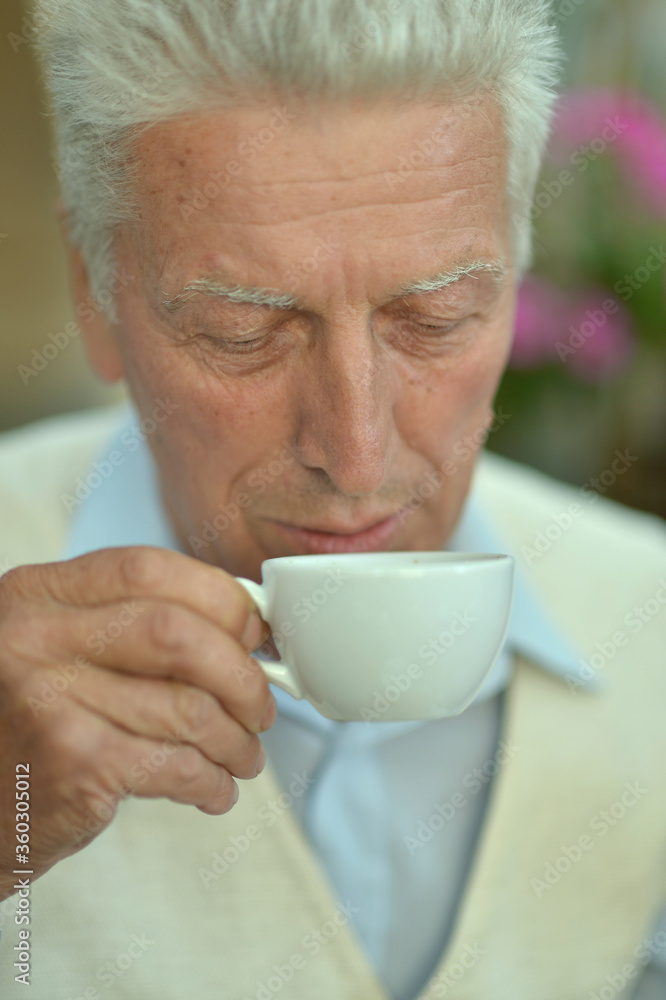 Portrait of cute senior man drinking coffee Portrait of cute senior man drinking coffee