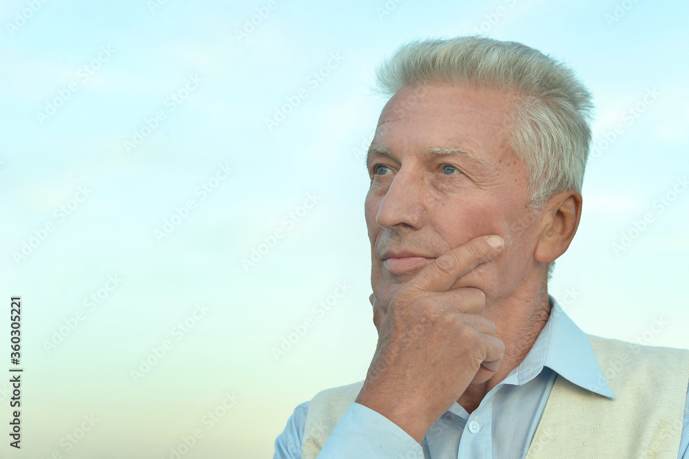 Portrait of senior man thinking in park Portrait of senior man thinking in park