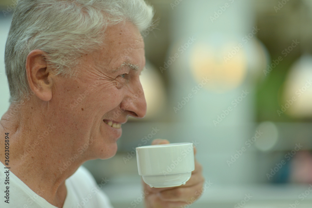 Portrait of smiling senior man drinking coffee Portrait of smiling senior man drinking coffee