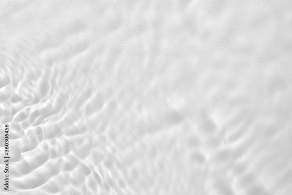 Closeup of desaturated transparent clear calm water surface texture with splashes and bubbles. Trendy abstract nature background. Closeup of desaturated transparent clear calm water surface texture with splashes and bubbles. Trendy abstract nature background.