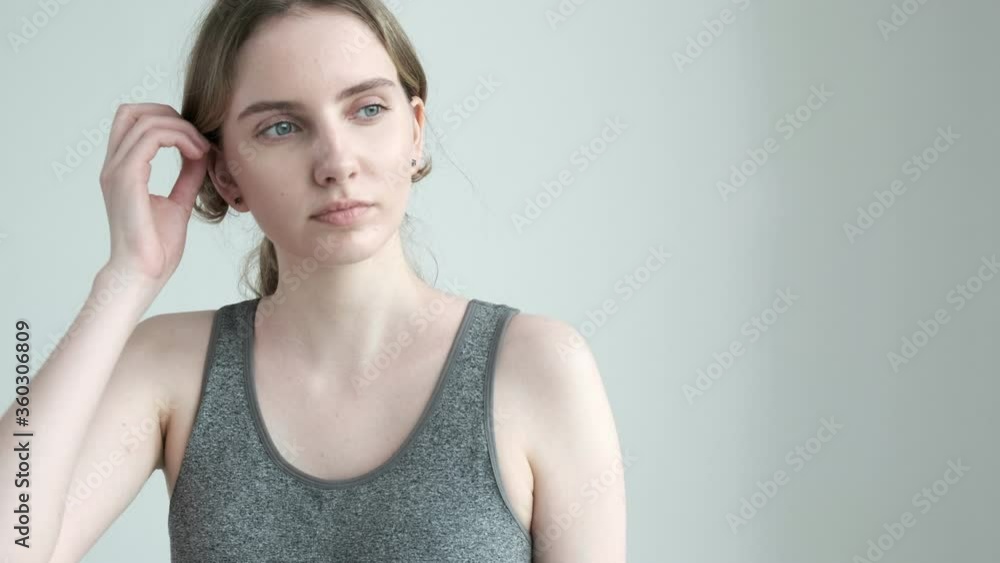 young sporty girl in sportswear standing on white background in silence. slim female in activewear waits for yoga class, fitness exercise, workout, dance lesson. morning routine, healthy lifestyle young sporty girl in sportswear standing on white background in silence. slim female in activewear waits for yoga class, fitness exercise, workout, dance lesson. morning routine, healthy lifestyle
