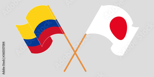 Crossed and waving flags of Colombia and Japan