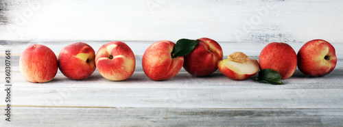 A group of ripe peaches on wooden table