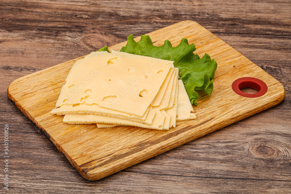 Sliced yellow cheese over board Sliced yellow cheese over board