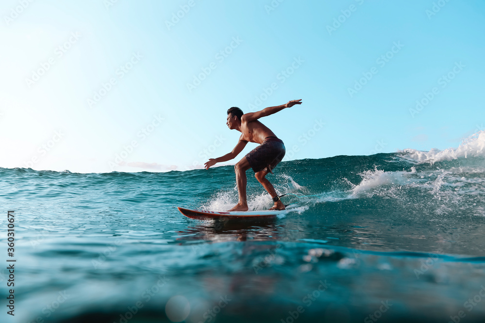 Surfer on a wave, Lombok, Indonesia Surfer on a wave, Lombok, Indonesia