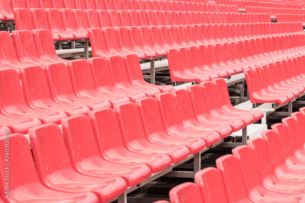 Fototapeta premium Rows of empty red grandstand seats, selective focus