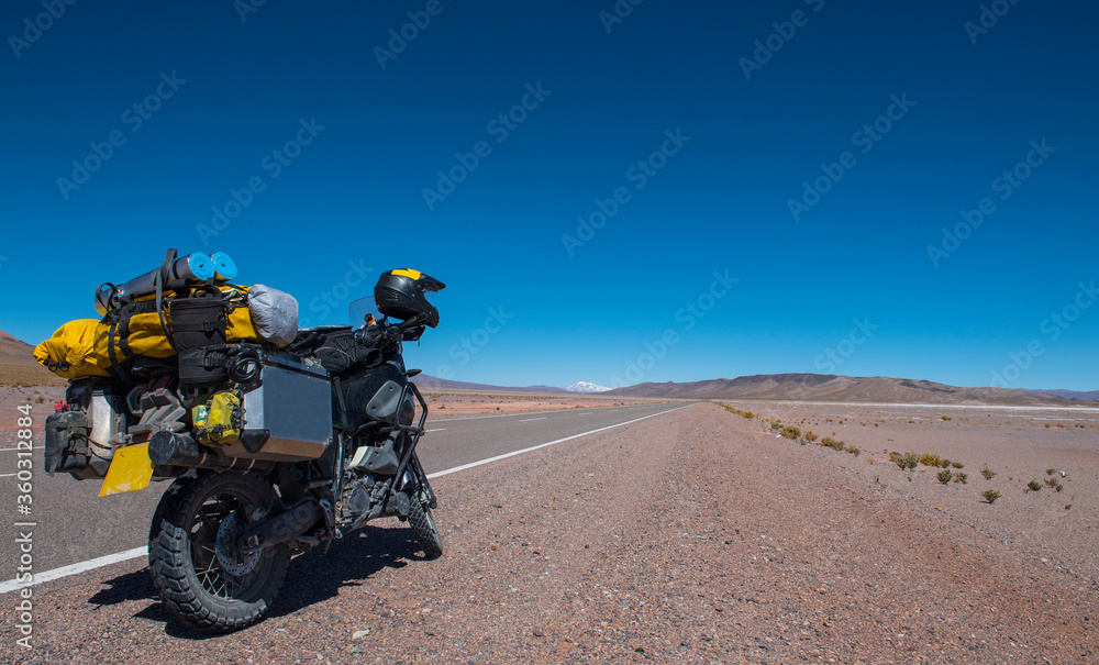 touring motorbike on side of a highway in the Atacama desert / Chile touring motorbike on side of a highway in the Atacama desert / Chile