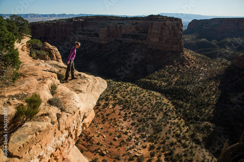 A young woman enjoys a view over Colorado National Monument in CO. photo